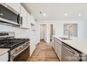 Modern kitchen with white cabinets, stainless steel appliances and an island at 109 Tallulah Ct, Statesville, NC 28625