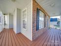 Side view of front porch with white railings and brown deck at 1385 The Xing, Rock Hill, SC 29732