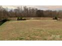 Landscaped community pond with fountain and seating area at 1916 Seefin Ct, Indian Trail, NC 28079