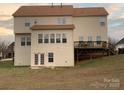 Two-story house back view, featuring a deck and walkout basement at 1916 Seefin Ct, Indian Trail, NC 28079