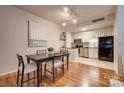 Eat-in kitchen with stainless steel appliances and light wood cabinets at 229 N Poplar St # 16, Charlotte, NC 28202