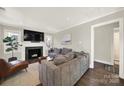 Spacious living room featuring a fireplace and large TV at 3120 Mathis Dr, Charlotte, NC 28208