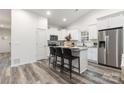 Modern kitchen with white cabinets, granite counters, and stainless steel appliances at 5517 Skycrest Dr, Charlotte, NC 28269