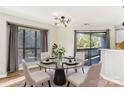 Elegant dining room with glass table, four chairs, and access to balcony at 8103 Cedar Glen Dr, Charlotte, NC 28212
