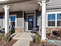 Inviting front porch with rocking chairs and white columns at 8825 Chapel Grove Crossing Dr, Huntersville, NC 28078