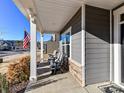 Covered porch with rocking chairs and American flag at 8825 Chapel Grove Crossing Dr, Huntersville, NC 28078