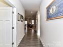Bright hallway with hardwood floors, leading to living areas at 8825 Chapel Grove Crossing Dr, Huntersville, NC 28078