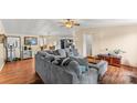 Open living space featuring a gray sectional sofa and ceiling fan at 980 Bear Poplar Rd, Cleveland, NC 27013