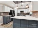 Modern kitchen featuring white and gray cabinets, quartz countertops, and stainless steel appliances at 1105 Stanback Rd, Chester, SC 29706