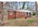 Cozy brick home featuring a well-maintained lawn and traditional design at 1418 Nottingham Rd, Kannapolis, NC 28081