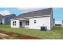 Newly constructed home showcasing a spacious backyard patio and grassy area at 150 Adams Tree Way, Troutman, NC 28166