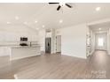 Open concept kitchen with an island, stainless steel appliances, and light flooring at 150 Adams Tree Way, Troutman, NC 28166