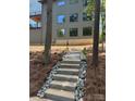 An exterior view shows landscaping and concrete stairs leading to a modern home with large windows at 150 Driftwood Dr, Mooresville, NC 28117