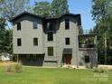 Three-story home featuring modern architecture and lush landscaping at 150 Driftwood Dr, Mooresville, NC 28117