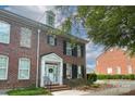 Charming brick townhome featuring a welcoming entrance, black shutters and well-maintained landscaping at 156 Singleton Rd, Mooresville, NC 28117