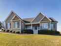 Gray house with a white front porch and landscaped yard at 1903 46Th Avenue Ne Dr, Hickory, NC 28601