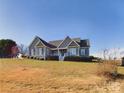 Gray house with a white front porch sits on a grassy lot at 1903 46Th Avenue Ne Dr, Hickory, NC 28601