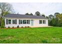 Charming white house with gray shutters, a light green door, and a large yard at 2085 Faith Rd, Salisbury, NC 28146