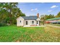 Tan house with gray roof, landscaping, and a spacious yard at 2500 S Ridge Ave, Kannapolis, NC 28083