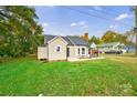 Tan house with gray roof, landscaping, and a spacious yard at 2500 S Ridge Ave, Kannapolis, NC 28083