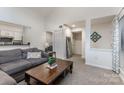 Open concept living room with seamless flow to the kitchen and wet bar, perfect for modern living at 421 N Church St # 12F, Charlotte, NC 28202