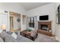 Bright living room with a cozy brick fireplace and large window, creating a warm and inviting space at 421 N Church St # 12F, Charlotte, NC 28202