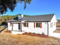 Charming white brick ranch home with wood accents and a spacious yard at 101 S Moose Rd, Mount Pleasant, NC 28124