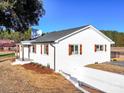 White brick house with a gray roof, wood accents, and a landscaped yard at 101 S Moose Rd, Mount Pleasant, NC 28124