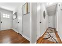 Bright hallway with hardwood floors and access to other rooms at 1122 Penrose Ln, Charlotte, NC 28217