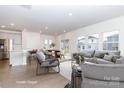 Virtually staged living room features gray couch and chairs, and kitchen with island at 1334 31St St # 6, Conover, NC 28613