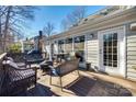 Spacious deck with wicker furniture, fire pit, and wooded backyard views at 2702 Oxborough Dr, Matthews, NC 28105