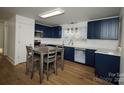 Modern kitchen with navy blue cabinets, white countertops, and stainless steel appliances at 3069 W Main St, Claremont, NC 28610