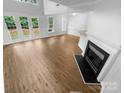 Open living room with hardwood floors, fireplace, and plenty of light from the windows at 4818 Whistling Oak Ct, Charlotte, NC 28269