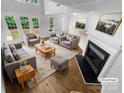 Bright living room with fireplace, hardwood floors, and neutral decor at 4818 Whistling Oak Ct, Charlotte, NC 28269