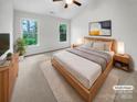 Inviting main bedroom with vaulted ceiling, carpet, and two bright windows at 4818 Whistling Oak Ct, Charlotte, NC 28269