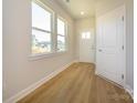 Bright entryway featuring natural light, wood flooring, and a modern white door at 119 Quartz Hill Way, Waxhaw, NC 28173