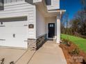 Close-up showing a home's front door and stone accents, enhancing curb appeal at 119 Quartz Hill Way, Waxhaw, NC 28173