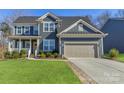 Two-story home with gray siding, large windows, and a two-car garage at 1224 Regions Blvd, Fort Mill, SC 29707