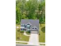 Beautiful two-story home with a well-manicured lawn, inviting front porch, and a two-car garage at 1224 Regions Blvd, Fort Mill, SC 29707