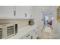 Modern kitchen with white cabinets, quartz countertops, and stainless steel appliances at 1224 Regions Blvd, Fort Mill, SC 29707