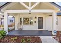 Inviting front porch with a hanging chair and stylish light fixtures at 1632 Arnold Dr, Charlotte, NC 28205