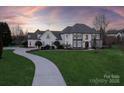 Elegant two-story home with stone accents and landscaped yard at 424 Fairhaven Ct, Waxhaw, NC 28173