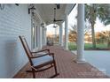 Brick porch with rocking chairs and lake view at 424 Fairhaven Ct, Waxhaw, NC 28173