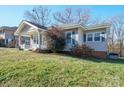 Tan colored bungalow with a side yard and mature trees at 625 N 3Rd St, Albemarle, NC 28001