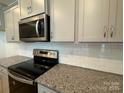 Stainless steel appliances and granite countertops highlighted in this kitchen at 6337 Mallow Crossing Ln, Charlotte, NC 28213