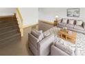 Virtually staged living room with modern furniture and stairs at 638 Chipley Ave # 6, Charlotte, NC 28205