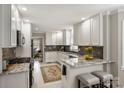 Well-lit kitchen featuring white cabinetry, granite countertops, and stainless steel appliances at 741 Mcalway Rd, Charlotte, NC 28211