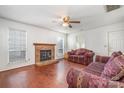 Living room with hardwood floors, brick fireplace, and comfy sofas at 9336 Amy Dr, Charlotte, NC 28213