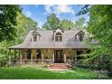 Charming two-story home with a wrap-around porch and landscaped yard at 1090 N Saunders Dr, Catawba, NC 28609