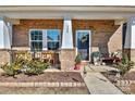 Inviting front porch with brick columns and comfy seating at 508 Cranford Dr, Pineville, NC 28134